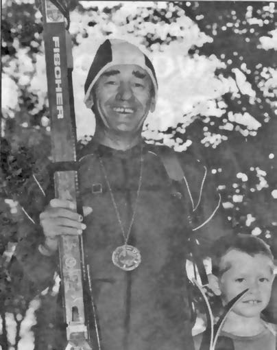 David St. Onge promotes local cross country skiing, with Dan Patterson at his side, by displaying his World Loppet Master's Medallion at the 1983 Ontario Little League Championship Parade in Perth.